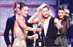  ??  ?? Models Bella Hadid, Jessica Hart, and Georgia Fowler at the amFAR gala. — AFP photo
