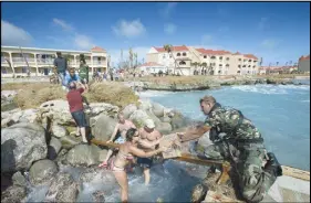  ?? AP PHOTO ?? A human chain of residents passing supplies provided by a dutch soldier after the passing of Hurricane Irma in Dutch Caribbean St. Maarten.