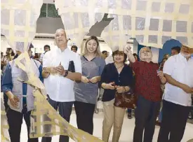  ??  ?? Paulina Luz Sotto-Llanes (third from left) cuts the innovative gallery curtain with (from left) Al Perez, Father Regent Edgardo Alaurin, Anita del Rosario, College of Fine Arts and Design Dean Cristie Que, Raul Isidro and 27 others.