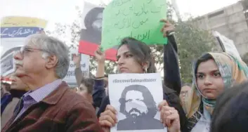  ??  ?? Pakistani rights activists hold images of bloggers who have disappeare­d during a protest in Lahore.