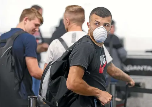  ?? GETTY IMAGES ?? Phoenix forward Jaushua Sotirio arrives at Wellington airport wearing a face mask for the team’s departure to Australia.