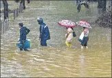  ?? PTI ?? People wade through a waterlogge­d street after heavy rain at Parel area in Mumbai on Wednesday.