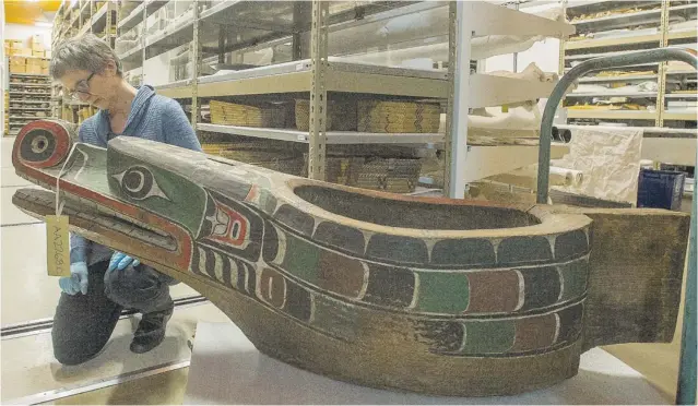  ?? PHOTOS BY RIC ERNST/ PNG ?? Joan Seidl, director of collection­s and exhibition­s at the Museum of Vancouver, examines a Kwakwaka’wakw feast bowl by Charlie James. It is one of three interconne­cting parts, used in potlatches.