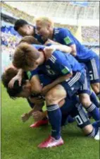  ?? EUGENE HOSHIKO — THE ASSOCIATED PRESS ?? Teammates crowd over Japan’s Shinji Kagawa after he scored his side’s first goal against Colombia during a Group H match in Saransk, Russia on Tuesday.