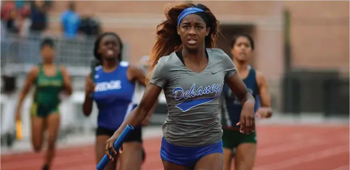  ?? Jerry Baker / for the Chronicle ?? Dekaney’s Keishawna Scott finishes the anchor leg for her team in the girls 200-meter relay at the District 15/16-6A area meet at Turner Stadium in Humble.