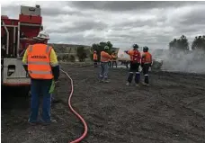  ??  ?? The New Acland Mine Emergency Response Team during the fire rescue scenario.