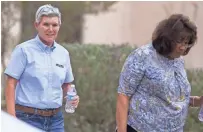  ?? SEAN LOGAN/ THE REPUBLIC ?? Arizona State Parks and Trails Director Sue Black (left) and a state official leave Sue Hartin’s home in El Mirage on Friday afternoon.