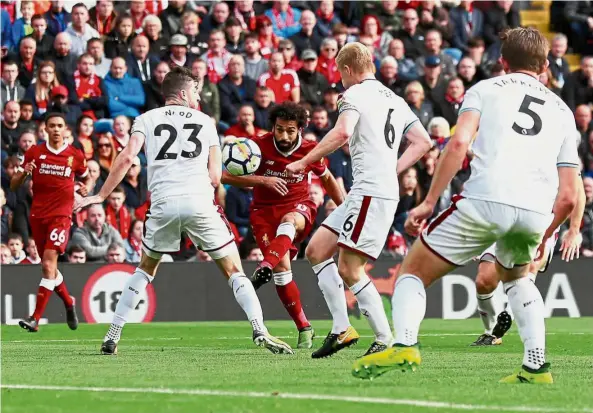  ?? — Reuters ?? Fire away: Liverpool’s Mohamed Salah taking a shot at goal in the match against Burnley at Anfield on Saturday.