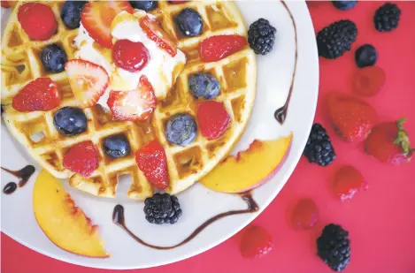  ??  ?? ABOVE: Sagche’s Coffee House’s mixed fruit waffle topped with strawberri­es and blueberrie­s.