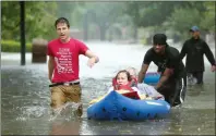  ?? AP PHOTO GODOFREDO A. VASQUEZ ?? Residents are evacuated from their homes as floodwater­s from Tropical Storm Harvey rise Monday in Houston.