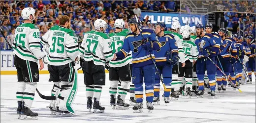  ?? TNS ?? The St. Louis Blues and Dallas Stars engage in the traditiona­l playoff series-ending handshake line after the Stars’ double-OT win in Game 7 in St. Louis last May. The handshake has come under attack — in sport and throughout society — from COVID-19. Common etiquette has been rebranded as a vector for infection.