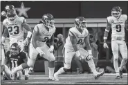  ?? NWA Democrat-Gazette/BEN GOFF ?? Arkansas linebacker De’Jon Harris (second from right) celebrates with teammates McTelvin Agim and Santos Ramirez (9) after sacking Texas A&amp;M quarterbac­k Kellen Mond for a 9-yard loss during the Razorbacks’ 24-17 loss Saturday to the Aggies at AT&amp;T Stadium in Arlington, Texas.