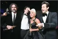  ?? Via Getty Images/TNS/Matt Petit) ?? Andrew Wyatt (from left), Anthony Rossomando, Lady Gaga and Mark Ronson pose with the Music (Original Song) award for “Shallow” from “A Star Is Born” backstage during the 91st Annual Academy Awards in 2019. Ronson and Wyatt’s “I’m Just Ken” from “Barbie” is seen as an Oscar nomination front-runner for original song. (A.M.P.A.S.