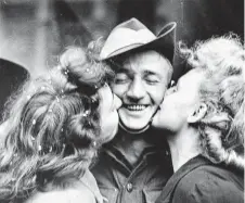  ?? An Australian soldier receives kisses on VP Day, 1945. ??