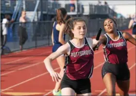  ?? AUSTIN HERTZOG — DIGITAL FIRST MEDIA ?? Pottsgrove’s Hannah Phillips receives the baton from leadoff runner Amiya Slade during the 4x400 relay.