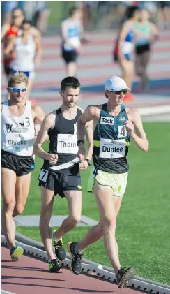  ??  ?? Evan Dunfee, front, and Ben Thorne, second, battle it out in a one-mile race walk at the Vancouver Sun Harry Jerome Track Classic at Percy Perry Stadium in Coquitlam on Wednesday. Thorne came out on top.