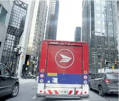  ?? POSTMEDIA NETWORK FILES ?? A Canada Post truck drives through the streets of Toronto in 2013.