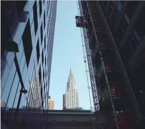  ?? — AFP ?? The iconic Chrysler Building an Art Deco–style skyscraper is seen between two buildings in Midtown Manhattan New York City, US, on Tuesday.