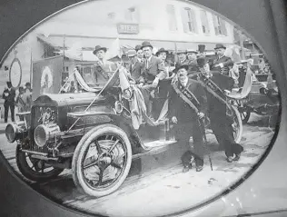  ?? Courtesy Marie O’Shaughness­y-Martin ?? Gilbert Ryan O’Shaughness­y, left in light-colored suit, president of the San Antonio Ancient Order of Hibernians, stands on the auto’s running board with sash and western-style hat in 1908.