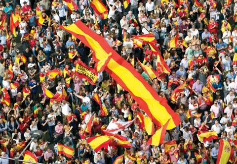  ??  ?? People wave Spanish national flags as thousands packed the central Cibeles square in Madrid, on Saturday. (AP)