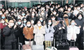  ??  ?? A GROUP of Chinese students makes hearts with their hands as they are released from a two-week isolation at a dormitory on the Jukjeon campus of Dankook University in Yongin, south of Seoul, South Korea, yesterday, amid the spread of the new coronaviru­s. | EPA