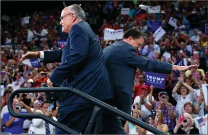  ?? The Associated Press ?? HIGH FIVE: Former New York Mayor Rudy Giuliani, left, high fives Gov. Pat McCrory, R-N.C., during a campaign rally for Republican presidenti­al candidate Donald Trump held Tuesday at the University of North Carolina Wilmington in Wilmington, N.C.