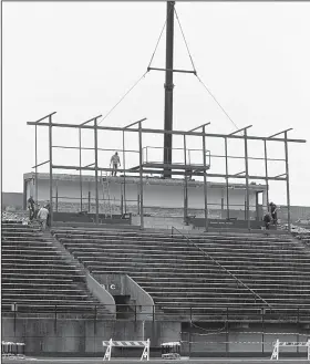  ?? File Photo ?? Stadium: The boom arm of a crane lowers framework onto the press box of Memorial Stadium in March. The stadium is undergoing an upgrade, which includes improvemen­ts to its facilities.