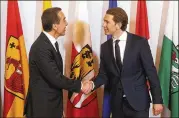  ?? RONALD ZAK / ASSOCIATED PRESS ?? Outgoing Austrian Chancellor Christian Kern (left) hands over the chanceller­y to his successor, Sebastian Kurz, after the swearing-in ceremony of the new Austrian government Monday in Vienna.