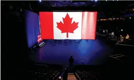  ?? Photograph: Mark Blinch/Reuters ?? A man stands under a giant Canadian flag before the Conservati­ve election party in Oshawa, Ontario, on 20 September 2021.