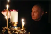  ?? MIKHAIL METZEL — SPUTNIK, KREMLIN POOL PHOTO VIA AP ?? Russian President Vladimir Putin lights a candle to commemorat­e the victims of an attack on the Crocus City Hall concert venue, on the day of national mourning, in Russia on Sunday.