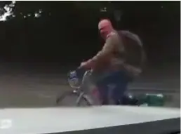  ?? ?? Pedal power: Patrick Harvie heads wrong way in dashcam footage, above, and riding his bike without a helmet, left