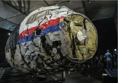  ??  ?? The reconstruc­ted wreckage (main picture) of Malaysia Airlines flight MH17 crash that killed 298 people over eastern Ukraine in July 2014. (Top right) Fred Westerbeke, Holland’s chief prosecutor, presents the interim results in the ongoing...