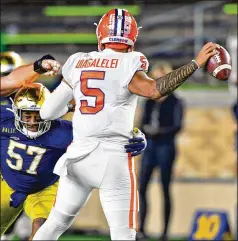  ?? MATT CASHORE/POOL/GETTY IMAGES/TNS ?? Clemson quarterbac­k D.J. Uiagalelei started two games last season because Trevor Lawrence, the likely first pick in the NFL draft in April, was out with COVID-19. Uiagalelei went 1-1, including a 47-40 double-overtime loss to Notre Dame.