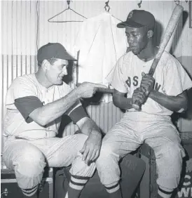  ?? ED MALONEY/AP ?? Elijah “Pumpsie” Green gets some friendly tips from Ted Williams while in Chicago in July 1959.