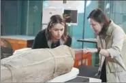  ?? PARKER ZHENG / CHINA DAILY ?? Experts examine a mummy at the Hong Kong Science Museum on Tuesday after it was removed from its transport crate. Six mummies, along with about 200 ancient artifacts on loan from the British Museum, will be displayed at an exhibition called
which...