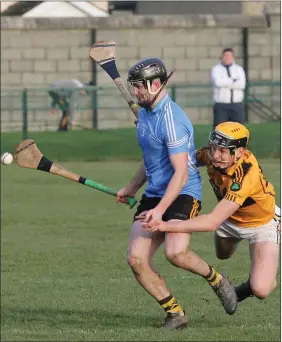  ??  ?? Conahy’s Eoin Cahill tries to flick the ball away from Darren Morris (Ballygarre­tt).