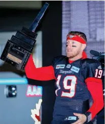  ?? AL CHAREST ?? Stampeders quarterbac­k Bo Levi Mitchell hoisted the West Division trophy Sunday, but he’s after the big one next Sunday.