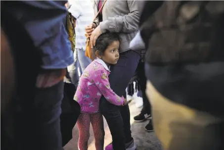  ?? Gregory Bull / Associated Press ?? Nicole Hernandez holds her mother as they wait Wednesday in Tijuana, Mexico, to request political asylum in the United States.