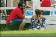  ??  ?? A woman prays in the grass outside the Alamo Gym where
parents wait to reunite with their kids following a shooting
at Santa Fe High School Friday, May 18, 2018, in Santa Fe,
Texas. (Michael Ciaglo/Houston Chronicle via AP)