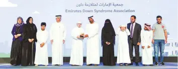  ??  ?? Shaikh Ahmad and Saeed Mohammad Al Tayer honours representa­tives of Emirates Down Syndrome Associatio­n, which won the Distinguis­hed Education Institutio­n in Conservati­on award in the People of Determinat­ion Centres category.