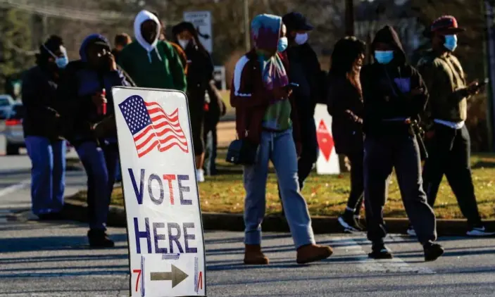  ?? Photograph: Mike Segar/Reuters ?? A sign directs people where to vote at a polling location in Marietta, Georgia, on 5 January.