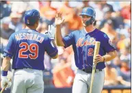  ?? Rich Schultz / Getty Images ?? Pete Alonso (20) of the New York Mets is congratula­ted by Devin Mesoraco (29) after scoring on a triple by Gregor Blanco in the second inning of a spring training game against the Houston Astros at Fitteam Ballpark of the Palm Beaches on March 11 in West Palm Beach, Fla.