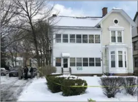  ?? NICHOLAS BUONANNO/THE RECORD VIA AP ?? Police secure the perimeter of a home in Troy, N.Y., on Tuesday after four bodies were discovered in a basement apartment. Troy police say the deaths are being treated as suspicious.