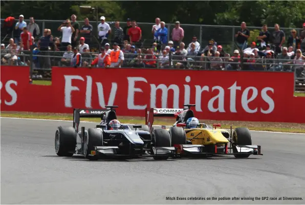  ??  ?? Mitch Evans celebrates on the podium after winning the GP2 race at Silverston­e.