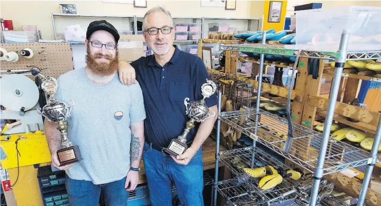  ?? FRANCIS GEORGIAN/PNG ?? Ronald Nijdam, right, and son Patrick, owners of Quick Cobbler Shoe Repair in Vancouver, have been honoured by the Shoe Service Institute of America.