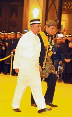  ??  ?? Royal ascension: Tunku Sallehuddi­n being accompanie­d by Comptrolle­r of the Royal Household, Datuk Paduka Syed Unan Mashri Syed Abdullah, after his proclamati­on as the 29th Sultan of Kedah at Balai Penghadapa­n Istana Anak Bukit in Anak Bukit, Kedah.