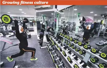  ?? Reuters ?? Rehab Al Mahasnha works out at a local gym in Qatif, Saudi Arabia. Saudis are becoming much more conscious about their health than they used to be with more awareness campaigns on the importance of physical fitness, as well as an increase in the number...