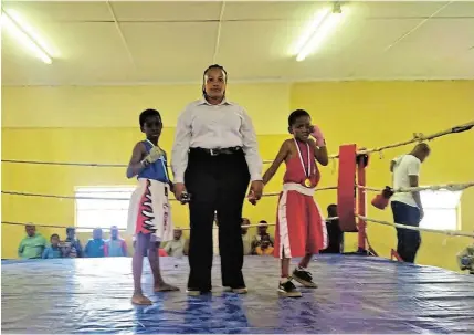  ?? Picture: SUPPLIED ?? AWAITING A DECISION: Aphelele Setasi and Siphesihle Ntwanambi wait for their referee, Bongiwe Nocanda to raise the winner’s hand after their bout.