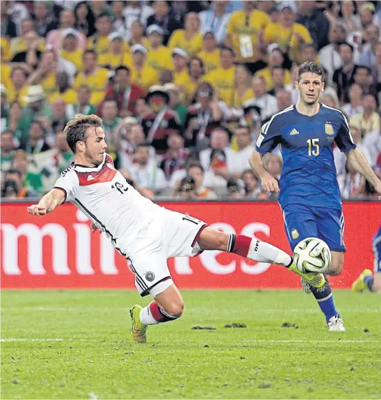  ??  ?? Germany’s Mario Goetze, left, scores the winning goal against Argentina in the 2014 World Cup final.