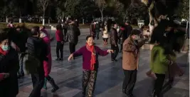  ?? GEtty IMAGES FILE ?? LEAVING THAT YEAR BEHIND: Elderly people, some without masks, dance in a public area in Wuhan, China, as the city marks a year since China confirmed its first death from COVID-19, on Jan. 11.